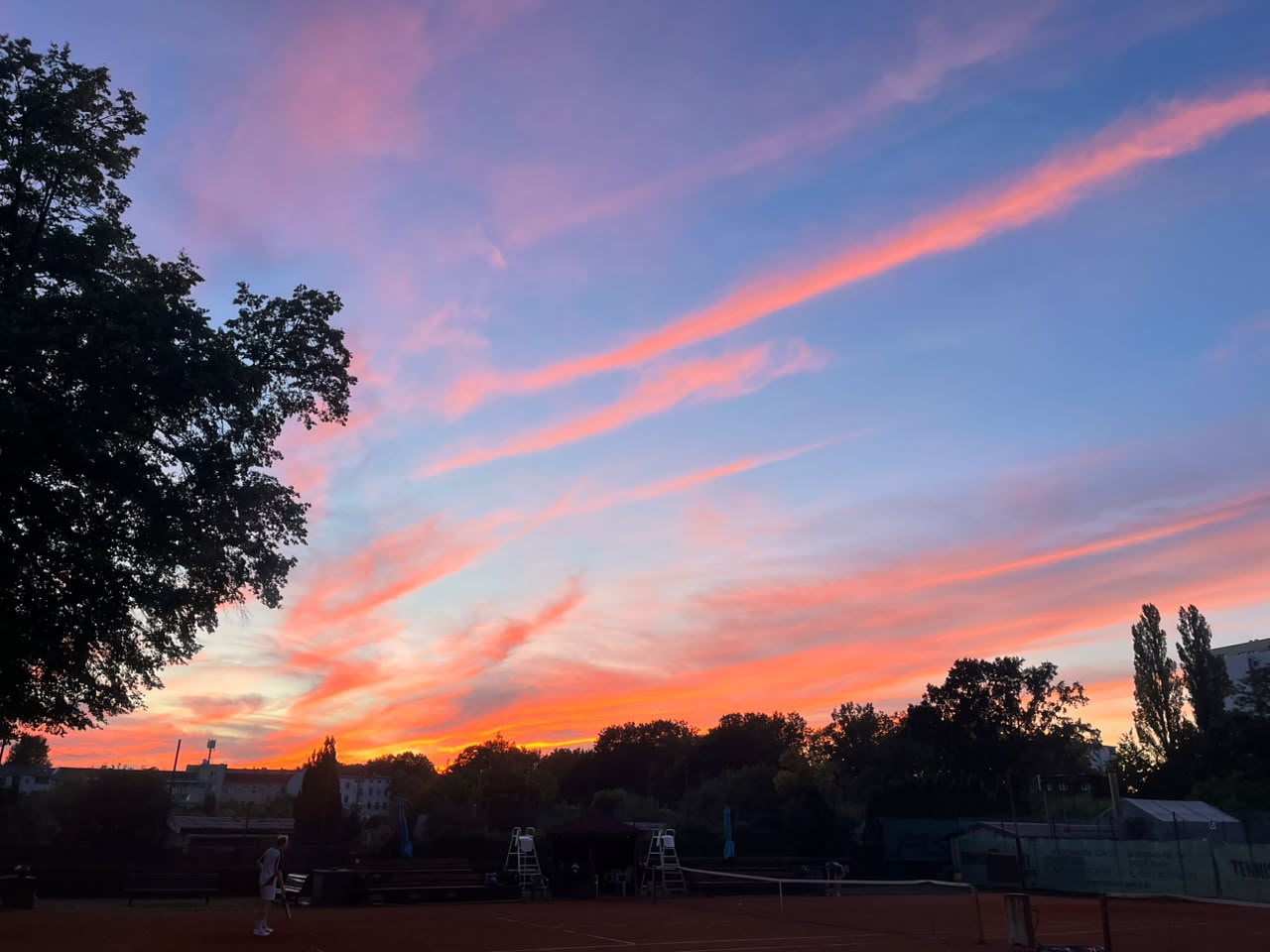 Sunset sky in pink and orange over the clay courts at BFC Alemannia, Berlin